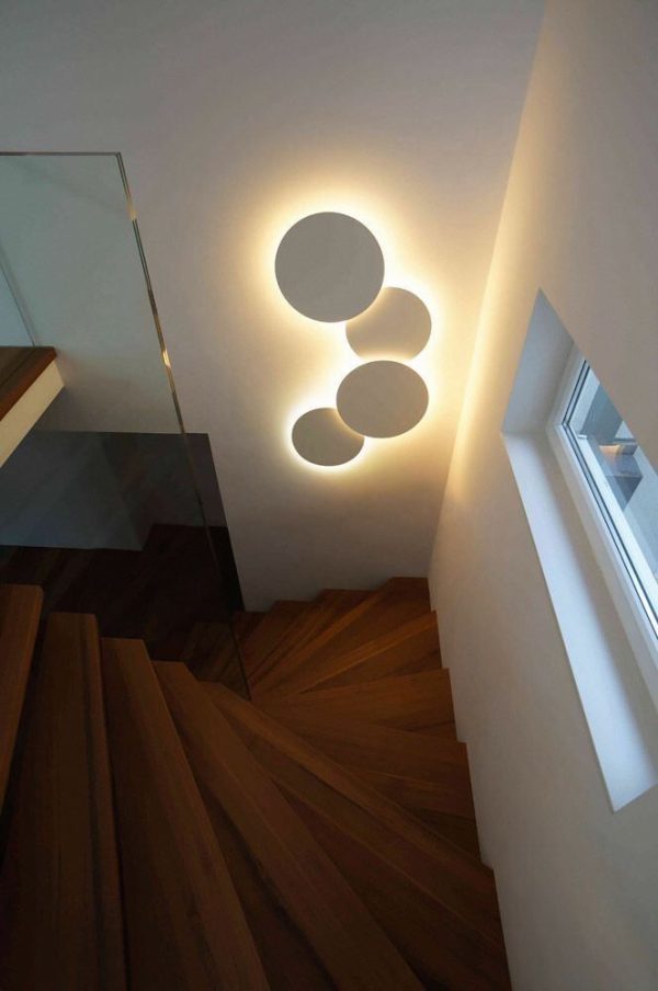 A staircase featuring circular lights overhead, enhancing the space with a modern and stylish design.